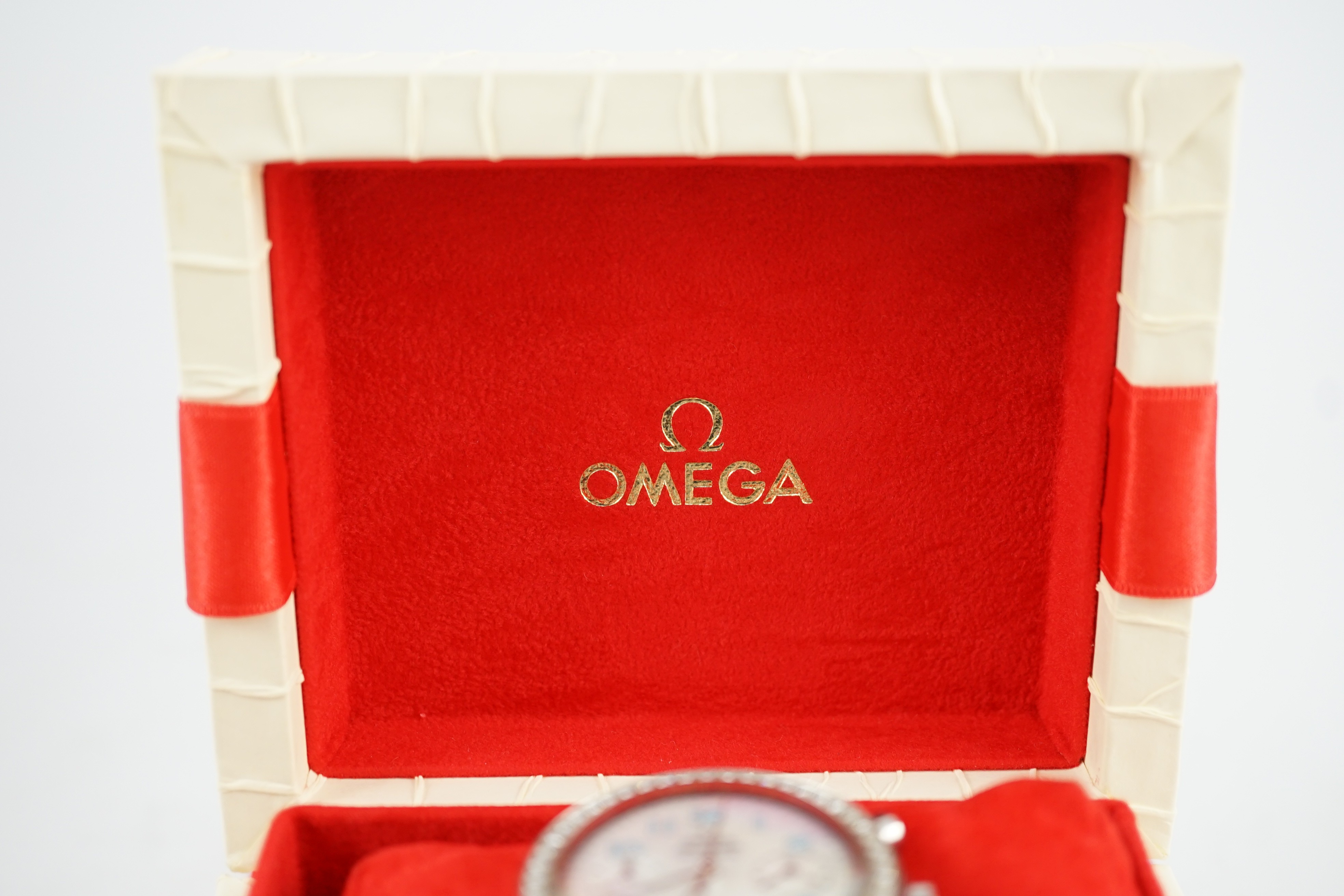 A lady's modern stainless steel Omega Speedmaster automatic wrist watch and bracelet, with mother of pearl Arabic dial and diamond set bezel